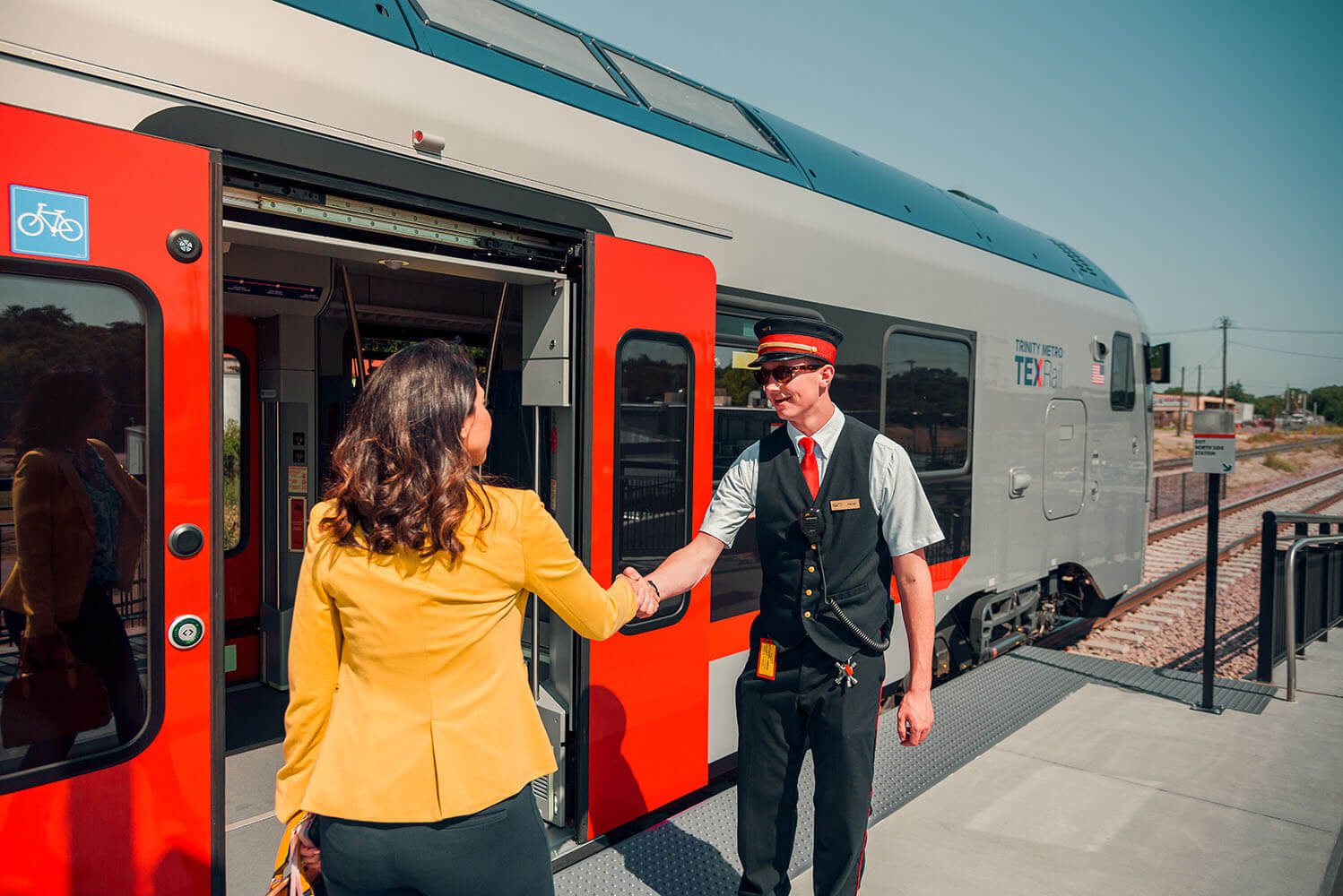 two people shaking hands before entering the train